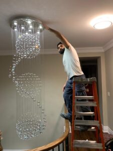 AMM Electric installing crystal chandelier