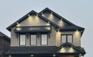 House exterior with soffit potlighting at dusk by AMM Electric