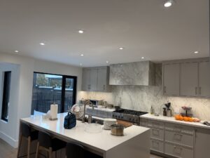 Kitchen with potlights and island lighting by AMM Electric
